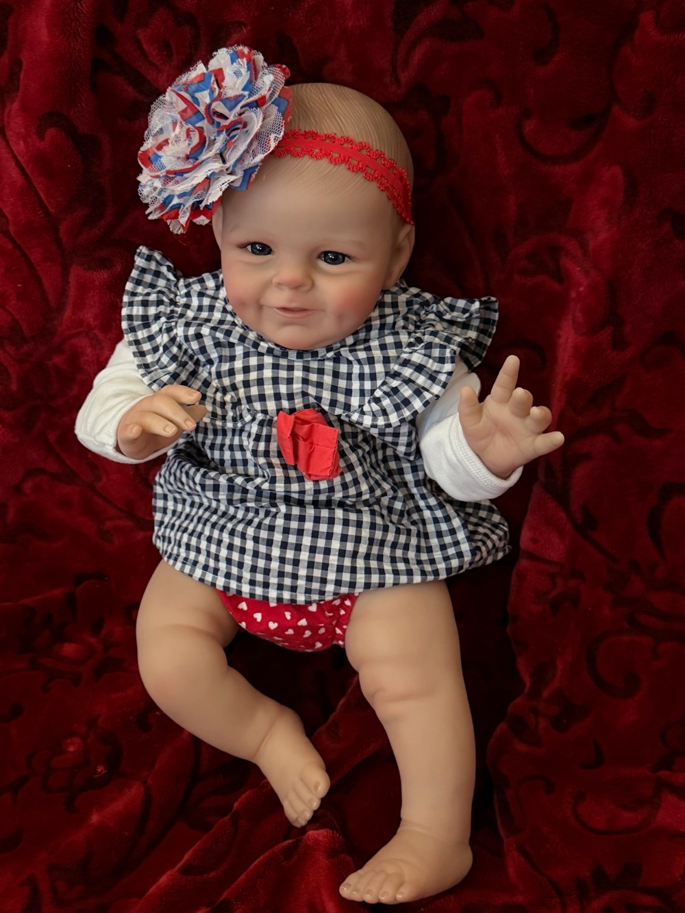 Realistic Baby Girl Doll in Pink Plaid Outfit with White Headband